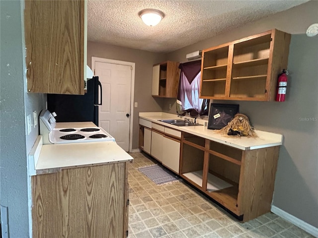 5101 Transport Rd, Bartow, FL 33830 - kitchen featuring white range with electric cooktop, a textured ceiling, light countertops, freestanding refrigerator, and open shelves