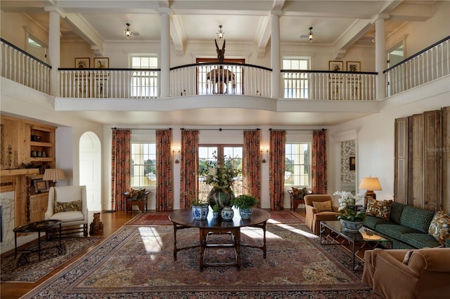 2300 Scenic Hwy N Unit 51, Lake Wales, FL 33898 - living area featuring a towering ceiling, decorative columns, healthy amount of natural light, beam ceiling, and a chandelier