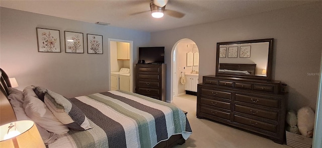 7201 Country Club Dr Unit G21, Lake Wales, FL 33898 - bedroom with washing machine and dryer, arched walkways, carpet floors, ensuite bathroom, and a ceiling fan
