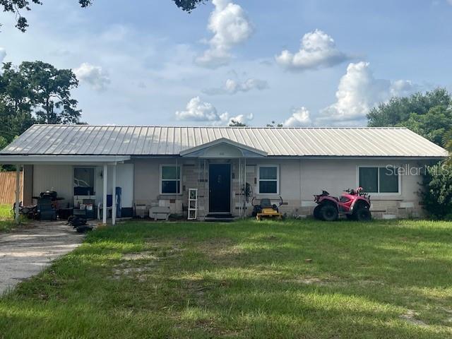 400 E Pomelo St, Lake Alfred, FL 33850 - back of property with a yard and a metal roof