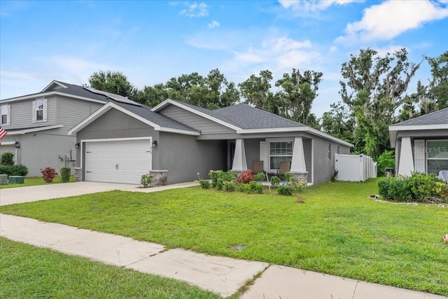 910 Blue Tide Ln, Lakeland, FL 33809 - view of front of property featuring a garage, driveway, stone siding, and stucco siding