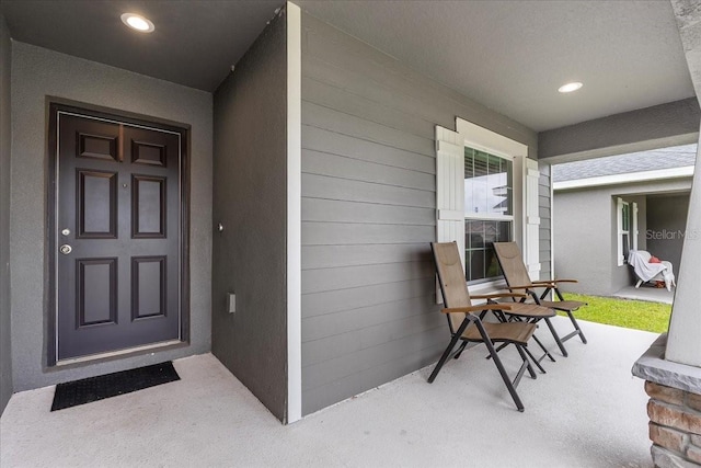 910 Blue Tide Ln, Lakeland, FL 33809 - property entrance with a porch and stucco siding