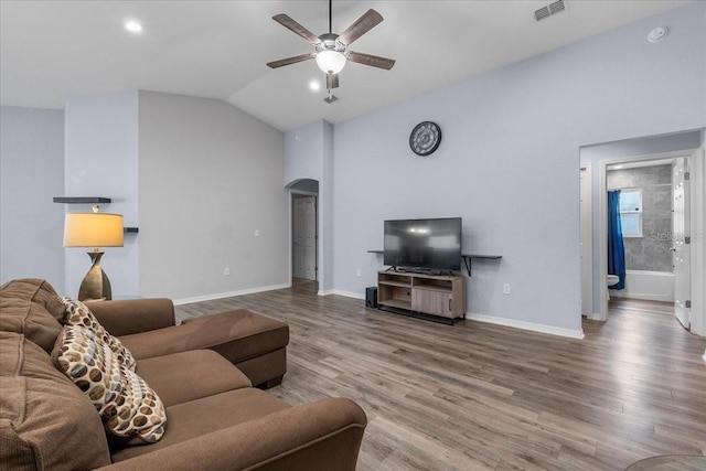910 Blue Tide Ln, Lakeland, FL 33809 - living room featuring arched walkways, a ceiling fan, wood finished floors, vaulted ceiling, and recessed lighting