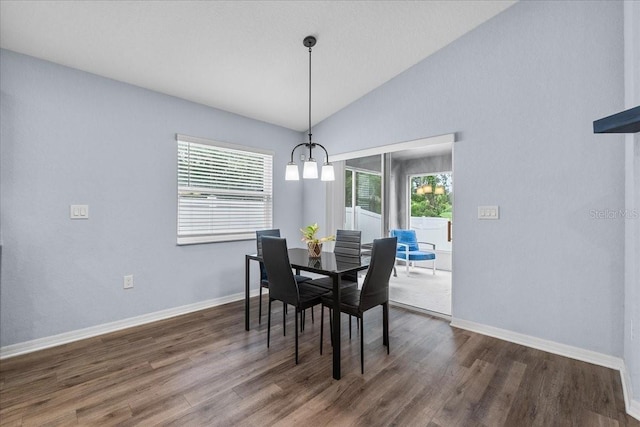 910 Blue Tide Ln, Lakeland, FL 33809 - dining room with lofted ceiling, dark wood-style flooring, and a chandelier