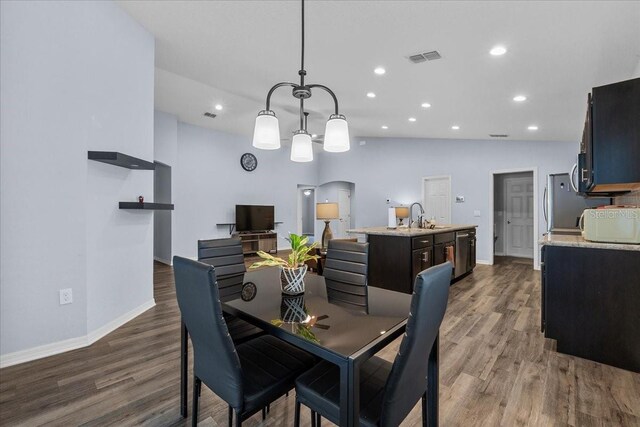 910 Blue Tide Ln, Lakeland, FL 33809 - dining space featuring wood finished floors, recessed lighting, and a chandelier