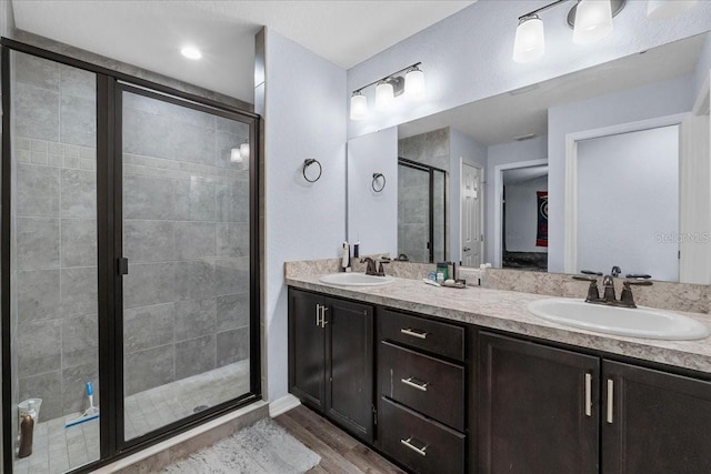 910 Blue Tide Ln, Lakeland, FL 33809 - full bath with a stall shower, double vanity, and wood finished floors