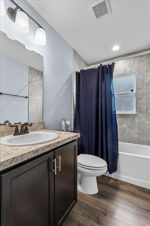 910 Blue Tide Ln, Lakeland, FL 33809 - full bathroom with vanity, wood finished floors, shower / tub combo, and a textured wall