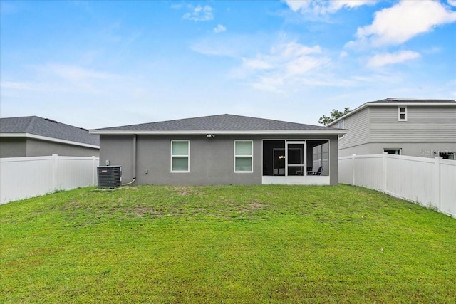 910 Blue Tide Ln, Lakeland, FL 33809 - rear view of property featuring a fenced backyard, a sunroom, stucco siding, and a shingled roof