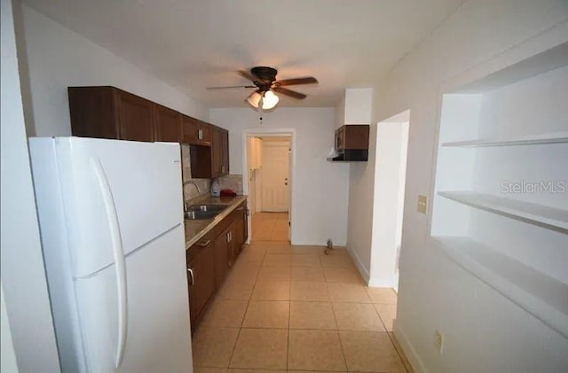 520 Oakland Rd, Auburndale, FL 33823 - kitchen featuring freestanding refrigerator, a ceiling fan, light tile patterned floors, light countertops, and dark brown cabinetry