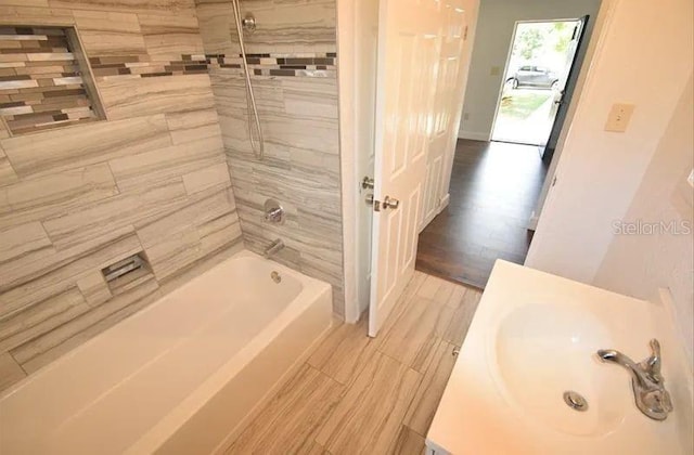 520 Oakland Rd, Auburndale, FL 33823 - full bathroom featuring vanity, shower / bath combination, and wood finished floors