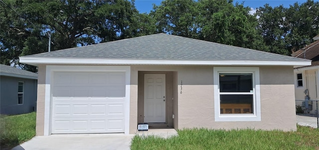 1736 3rd St NE, Winter Haven, FL 33881 - view of front facade featuring a shingled roof, stucco siding, driveway, and a garage