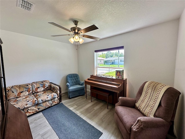 1736 3rd St NE, Winter Haven, FL 33881 - sitting room featuring wood finished floors, a ceiling fan, and a textured ceiling