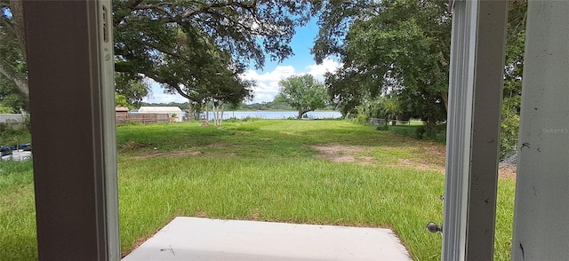 1736 3rd St NE, Winter Haven, FL 33881 - view of green lawn featuring a water view and a patio