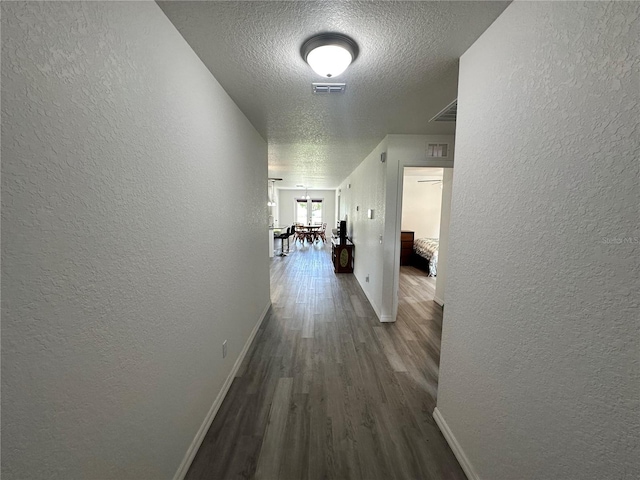1736 3rd St NE, Winter Haven, FL 33881 - hallway with a textured wall, a textured ceiling, and wood finished floors