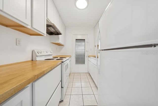 1700 6th St NW Unit A38, Winter Haven, FL 33881 - kitchen with white appliances, under cabinet range hood, white cabinetry, and light tile patterned flooring