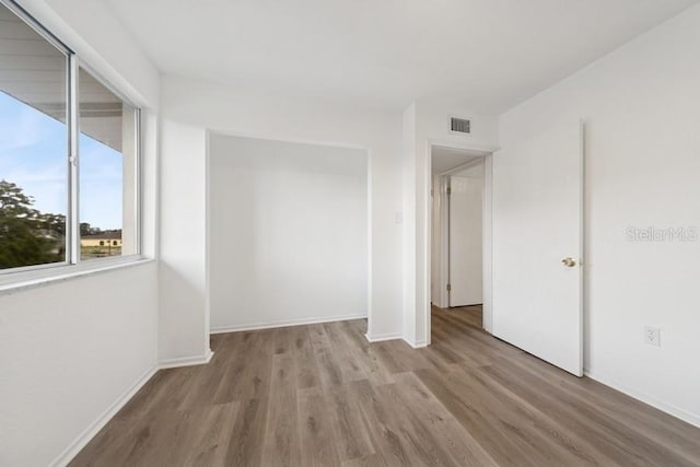 1700 6th St NW Unit A38, Winter Haven, FL 33881 - unfurnished room with wood finished floors and baseboards