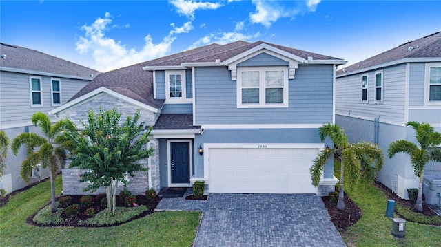 2090 Lelani Cir, Davenport, FL 33897 - traditional-style home with decorative driveway, a garage, and roof with shingles