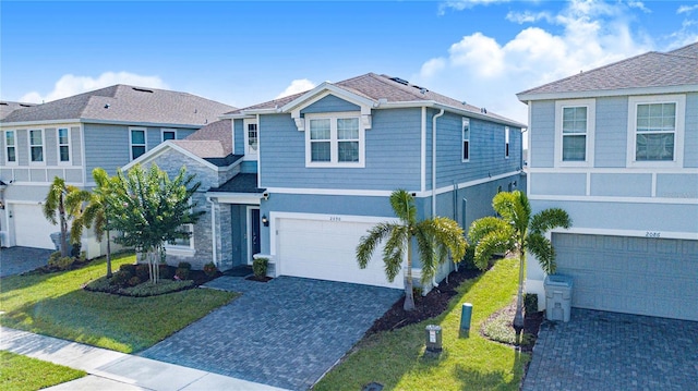 2090 Lelani Cir, Davenport, FL 33897 - view of front of property with an attached garage, decorative driveway, a front yard, and stucco siding