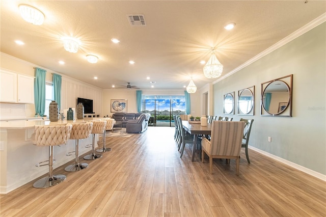 2090 Lelani Cir, Davenport, FL 33897 - dining area with ornamental molding, light wood-style flooring, a ceiling fan, a chandelier, and recessed lighting