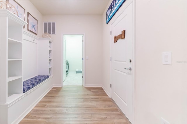 2090 Lelani Cir, Davenport, FL 33897 - mudroom featuring light wood-style flooring and baseboards