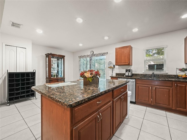 3747 Woodbury Hill Loop, Lakeland, FL 33810 - kitchen with dishwasher, light tile patterned flooring, a kitchen island, recessed lighting, and dark stone counters
