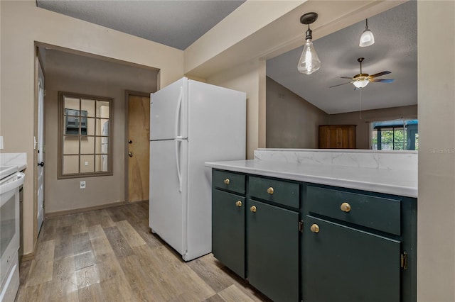3408 Cove Ct W, Winter Haven, FL 33880 - kitchen with green cabinets, freestanding refrigerator, light wood finished floors, a ceiling fan, and light countertops
