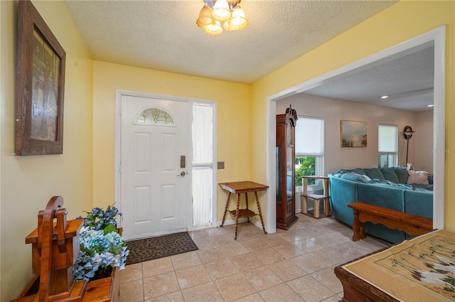 305 Hernando Rd, Winter Haven, FL 33884 - entrance foyer with a textured ceiling and light tile patterned floors