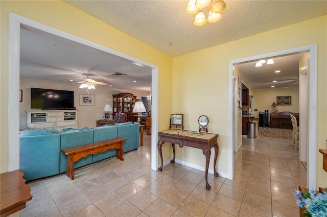 305 Hernando Rd, Winter Haven, FL 33884 - living area featuring a ceiling fan, a textured ceiling, and light tile patterned floors