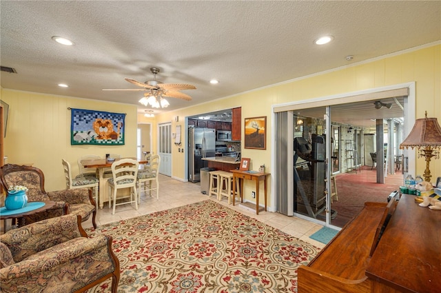 305 Hernando Rd, Winter Haven, FL 33884 - living room with a ceiling fan, a textured ceiling, recessed lighting, light tile patterned flooring, and crown molding