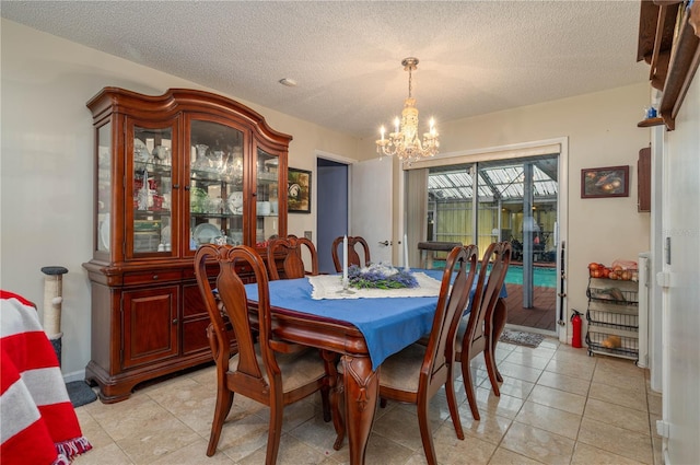 305 Hernando Rd, Winter Haven, FL 33884 - dining space featuring a chandelier, a textured ceiling, and light tile patterned floors