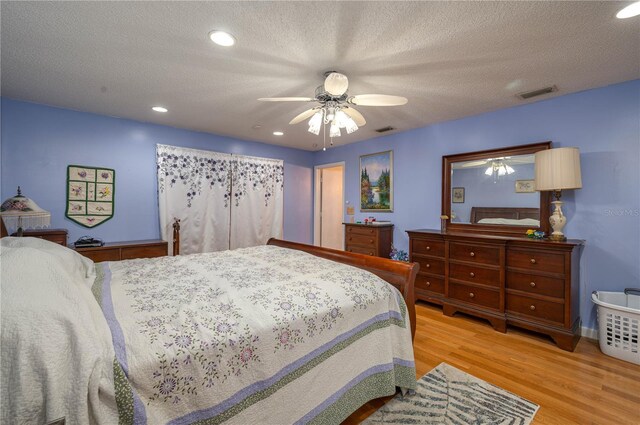 305 Hernando Rd, Winter Haven, FL 33884 - bedroom with wood finished floors, recessed lighting, a ceiling fan, and a textured ceiling