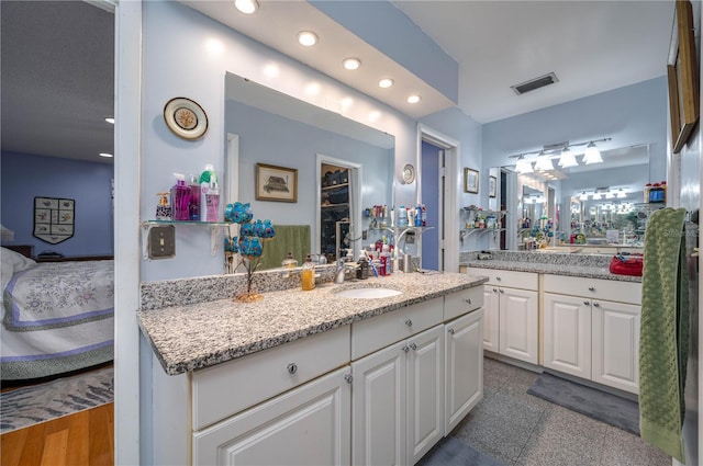 305 Hernando Rd, Winter Haven, FL 33884 - bathroom with recessed lighting, connected bathroom, vanity, and granite tiled floors