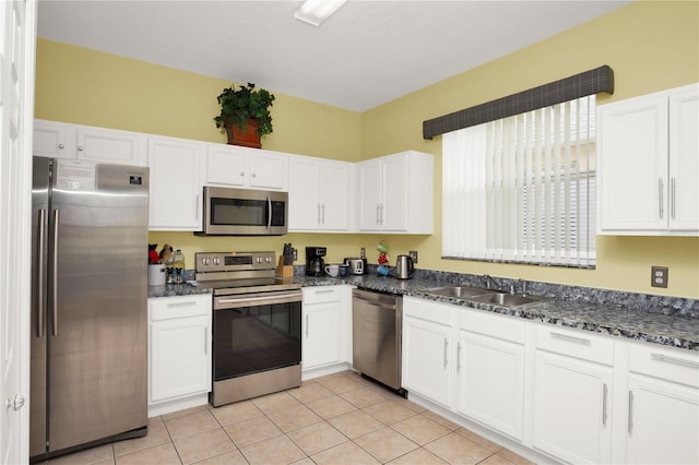 142 Plumoso Loop, Davenport, FL 33897 - kitchen with appliances with stainless steel finishes, white cabinetry, and light tile patterned flooring