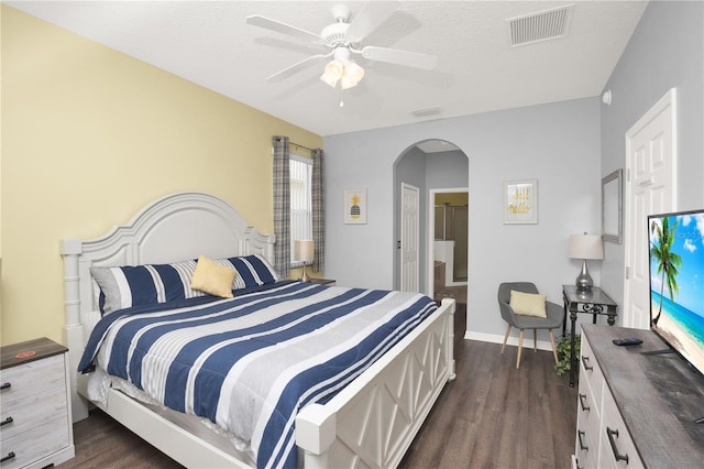 142 Plumoso Loop, Davenport, FL 33897 - bedroom with arched walkways, dark wood-style flooring, and ceiling fan