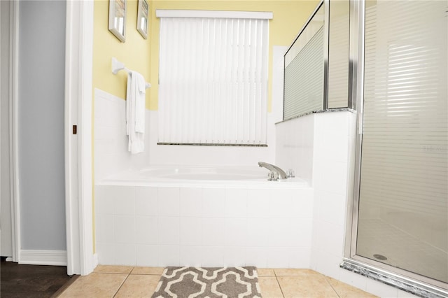 142 Plumoso Loop, Davenport, FL 33897 - full bathroom featuring a garden tub, a stall shower, and tile patterned flooring