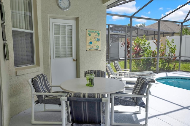 142 Plumoso Loop, Davenport, FL 33897 - view of patio / terrace featuring glass enclosure, an outdoor pool, and outdoor dining space