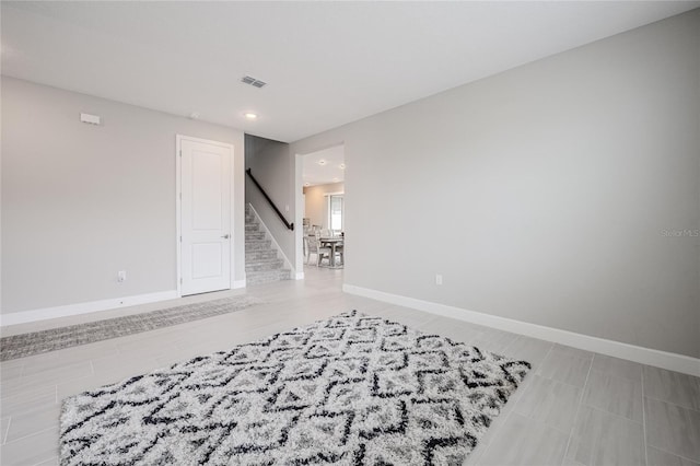 1504 Aspen Ave, Davenport, FL 33837 - empty room with stairs and recessed lighting