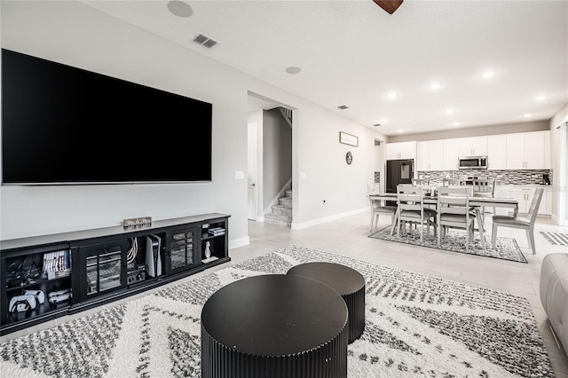 1504 Aspen Ave, Davenport, FL 33837 - living room with stairway, light wood-type flooring, and recessed lighting