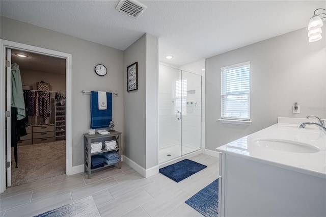 1504 Aspen Ave, Davenport, FL 33837 - full bath with a shower stall, a spacious closet, double vanity, and a textured ceiling