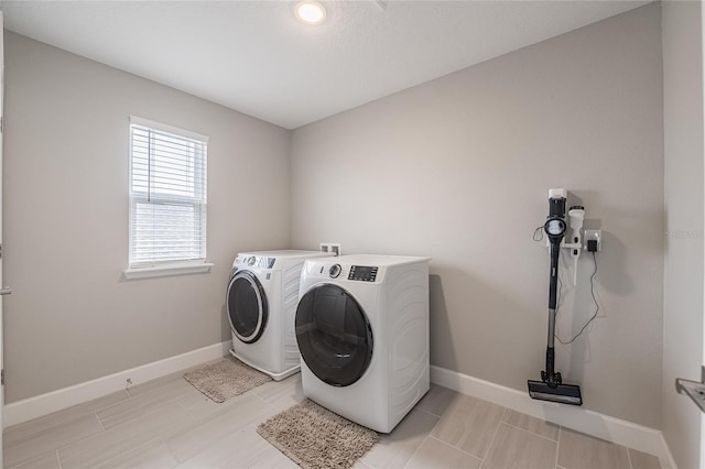1504 Aspen Ave, Davenport, FL 33837 - laundry room with separate washer and dryer and baseboards