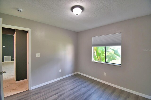 2123 Ramsdale Dr SE, Palm Bay, FL 32909 - spare room featuring a textured ceiling, wood finished floors, and a smoke detector
