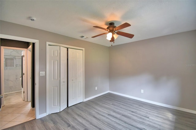 2123 Ramsdale Dr SE, Palm Bay, FL 32909 - unfurnished bedroom featuring a closet, wood finished floors, and a ceiling fan