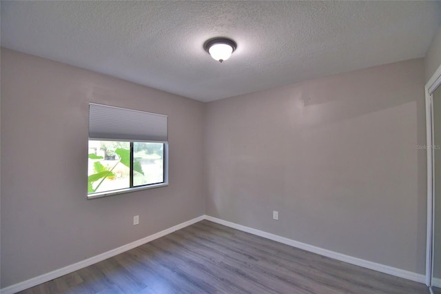 2123 Ramsdale Dr SE, Palm Bay, FL 32909 - spare room with dark wood-style flooring and a textured ceiling