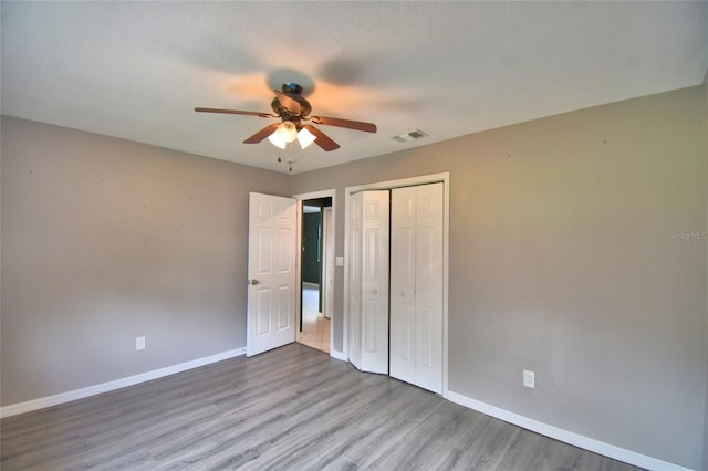 2123 Ramsdale Dr SE, Palm Bay, FL 32909 - unfurnished bedroom featuring wood finished floors, a closet, and ceiling fan