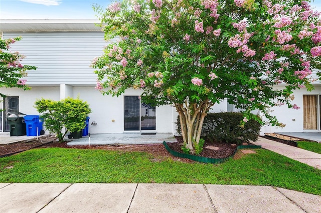222 Carpenters Way Unit 73, Lakeland, FL 33805 - rear view of house featuring a yard and stucco siding