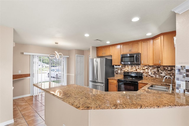 222 Carpenters Way Unit 73, Lakeland, FL 33805 - kitchen with appliances with stainless steel finishes, light stone countertops, backsplash, a peninsula, and light tile patterned floors