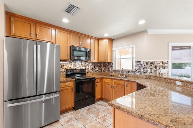 222 Carpenters Way Unit 73, Lakeland, FL 33805 - kitchen with appliances with stainless steel finishes, ornamental molding, healthy amount of natural light, decorative backsplash, and light stone countertops