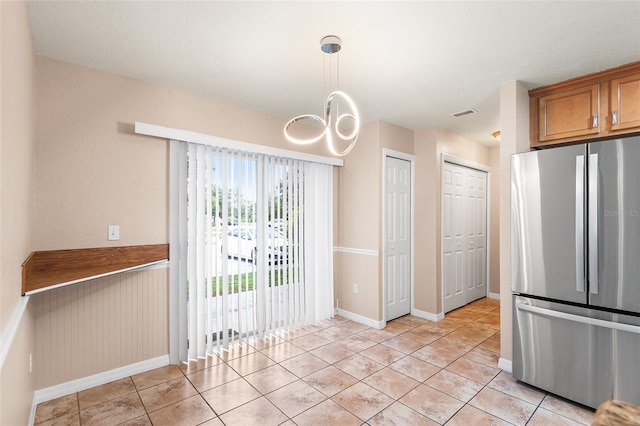 222 Carpenters Way Unit 73, Lakeland, FL 33805 - unfurnished dining area with light tile patterned flooring and a chandelier