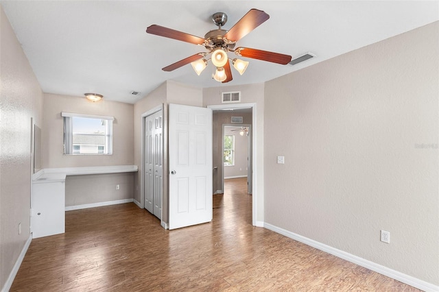 222 Carpenters Way Unit 73, Lakeland, FL 33805 - empty room with ceiling fan and wood finished floors