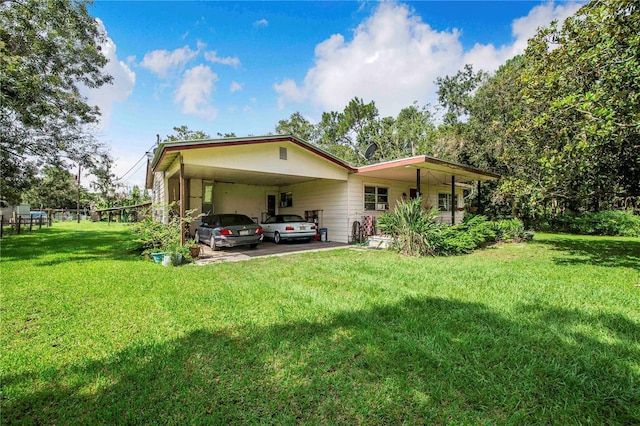 4430 1st St NW, Lakeland, FL 33810 - back of property with an attached carport and a lawn